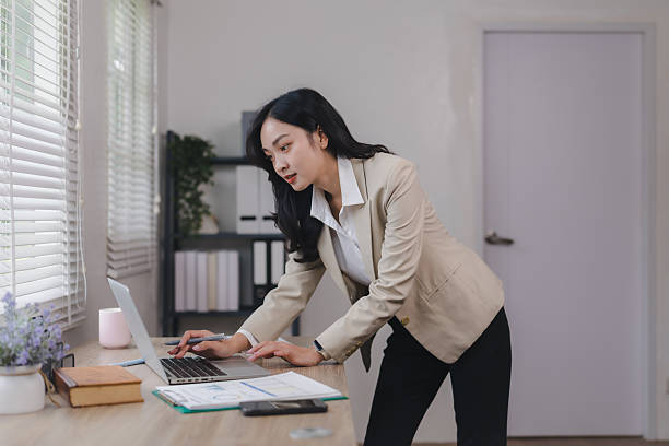 istock Young asian businesswoman working using laptop in modern office 2225923041