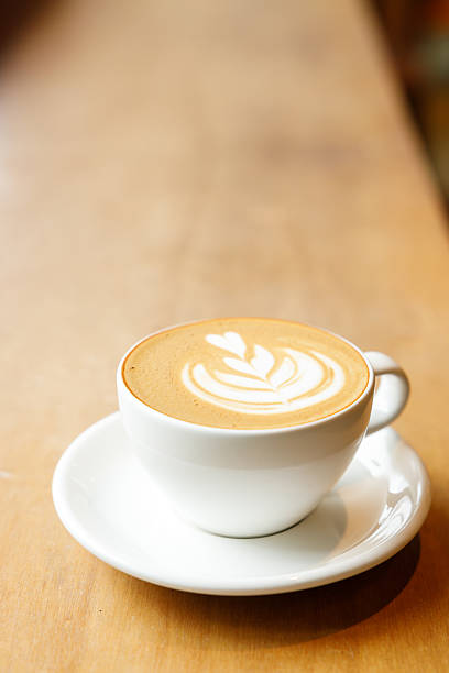 istock Cup of hot milk latte coffee on table by the window. 2225924601