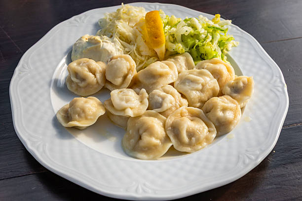 Traditional Polish dumplings served with cabbage salad and creamy dressing in Bialowieza, Poland.