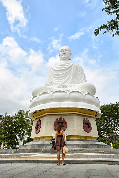 istock Woman Exploring Ancient Buddha Statue in Vietnam 2225930941