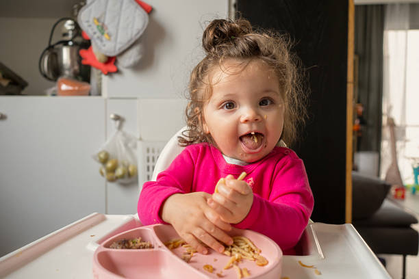 istock Joyful Toddler Eating Spaghetti at Home 2225932073