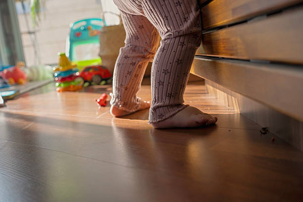 istock Barefoot Toddler Standing Indoors in Sunlight 2225933999