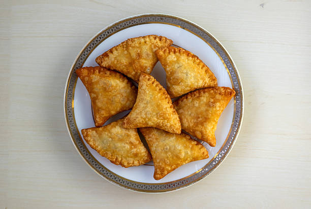 istock Crispy deep-fried beef samosa pastries served on a white plate, a beloved culinary delight across South Asia including India, Pakistan, and Bangladesh. Other names include sanbusaq, sanbusaj, samoosa. 2225934974