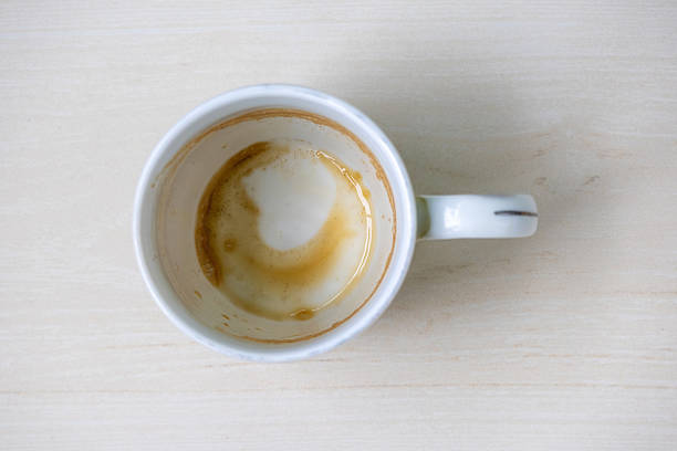 istock Close-up of an empty white ceramic mug with residual coffee or tea stains, viewed from above. Perfect for beverage, morning, or kitchen concepts, highlighting realistic used drinkware. 2225935377