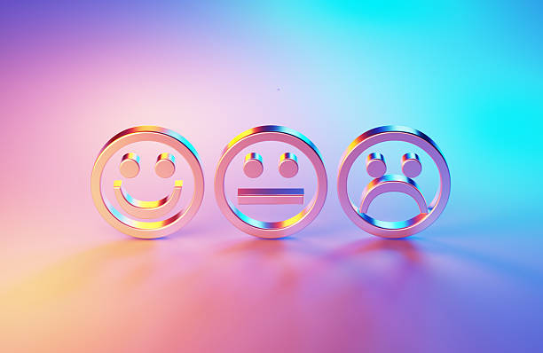 Metallic smiley and sad faces illuminated by blue and magenta lights . Horizontal composition with copy space. - Feedback concept.