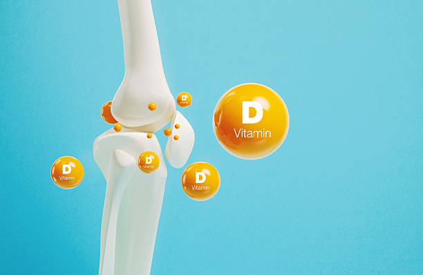 Vitamin D written orange molecules revolving around human joint on blue background. Bone health and active lifestyle concept.