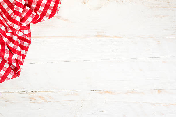 istock Kitchen table with red plaid tablecloth at white wooden table. 2225941233