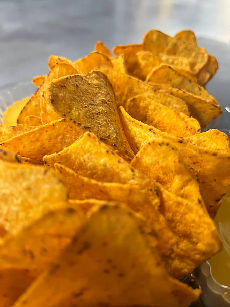 istock Crispy golden yellow nacho chips piled high, creating a delicious snack or appetizer, perfect for casual dining, movie nights, or lively party gatherings 2225941318