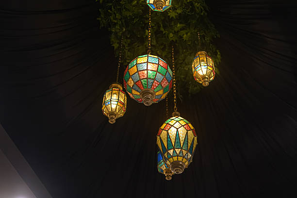 Colorful Stained Glass Hanging Lanterns Illuminating a Dark Ceiling with Elegant Ambience