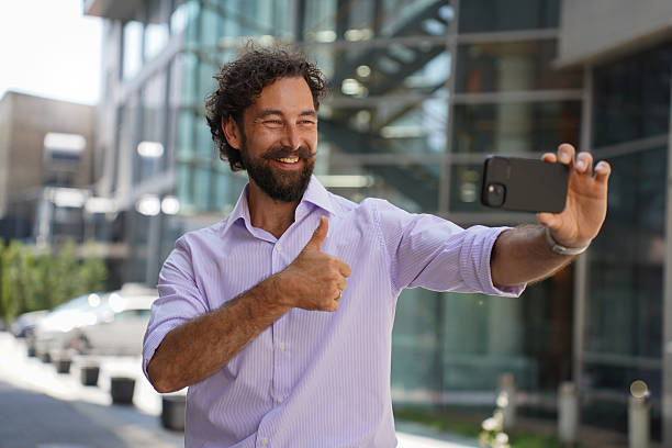 istock Confident businessman using smartphone outdoors in urban cityscape 2225942598