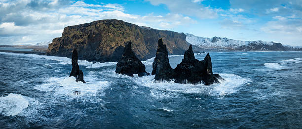 Iceland Reynisdrangar Basalt Sea Stacks Crashing Waves in Vik Drone Winter Panorama