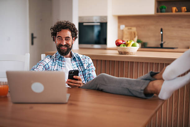 istock Freelancer working remotely from home office using laptop and smartphone 2225945862