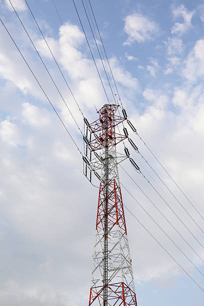 istock Red and white high-voltage transmission tower in Japan against a cloudy sky. 2225947016
