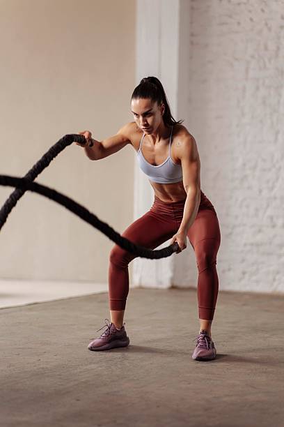 istock Determined Fit Woman Training With Battle Ropes 2225947892