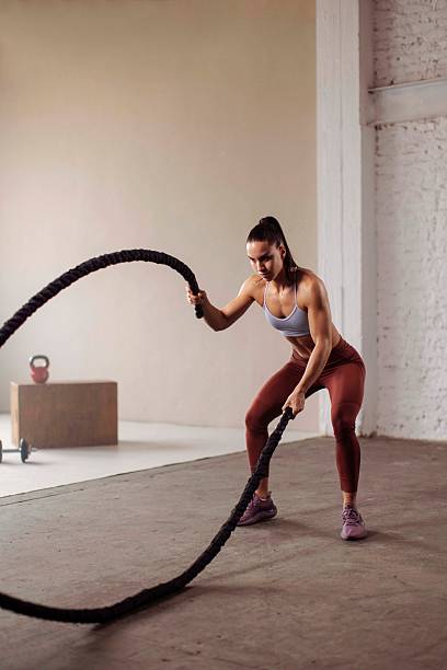 istock Muscular Sportswoman Training With Battle Ropes 2225947988