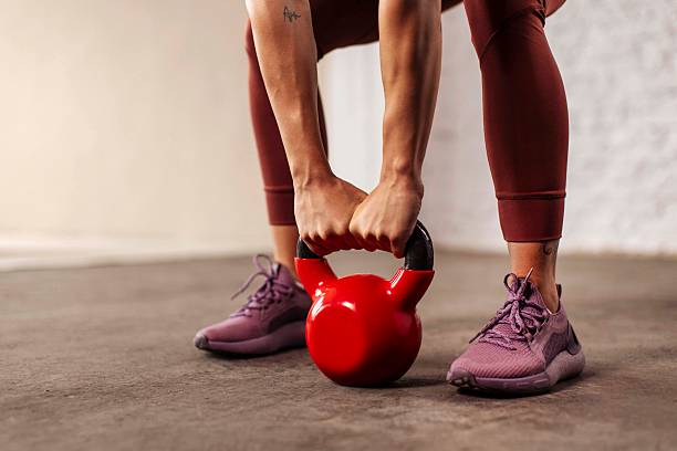 istock Strong Sportswoman Lifting Red Kettlebell in Gym 2225949253