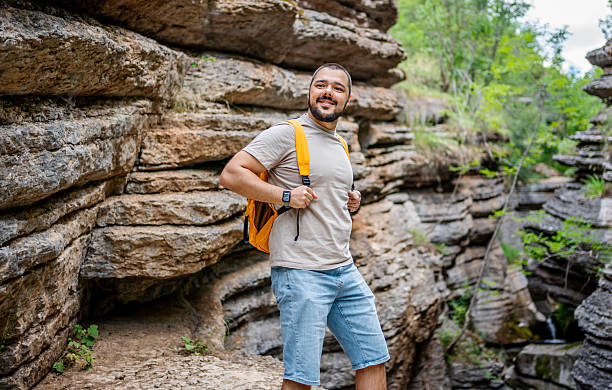 istock Young male hiker exploring picturesque canyon with backpack 2225949961