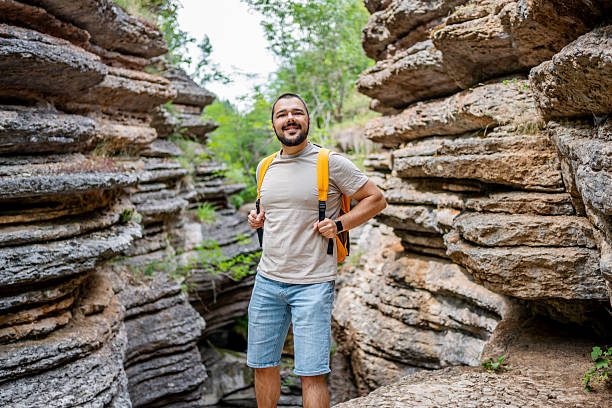 istock Young male hiker exploring canyon with backpack and hiking shorts 2225950138
