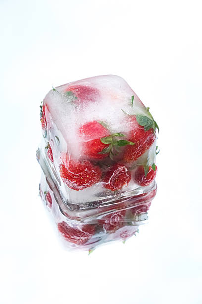 istock Strawberries encased in a transparent ice cube, isolated on a white reflective surface. Concept of freshness and preservation 2225950404