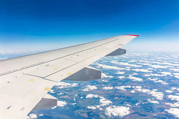 istock View from the airplane window at a beautiful cloudy sky and the airplane wing 2225951664