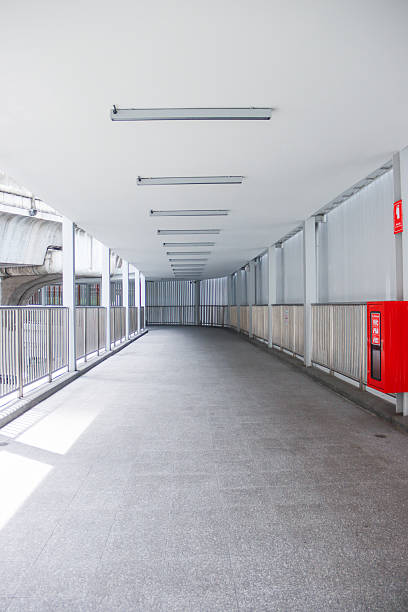 Empty Covered Walkway with Red Fire Hose Cabinet and Long Perspective