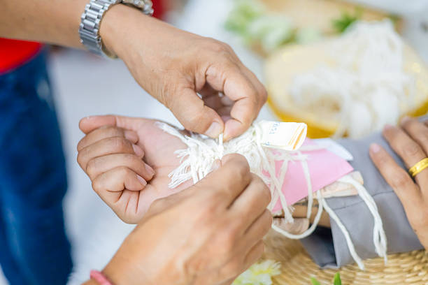 istock Thai Wedding Wrist Tying Ceremony with Sacred Thread 2225956859
