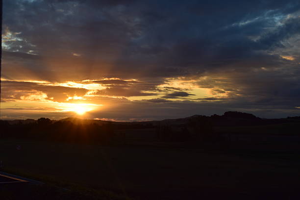 istock glowing winter sunrise with gloomy clouds 2225961763