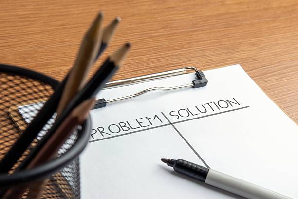 istock Closeup image of paper clipboard with PROBLEM and SOLUTION written on its pages. 2225962136