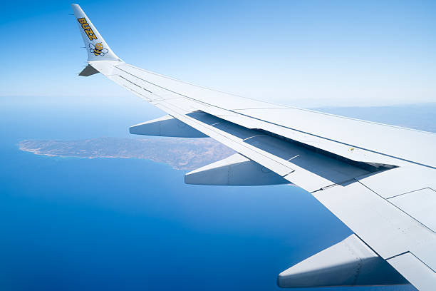 Wing Ryanair plane seen from window over holiday island Cyprus. Concept air travel.