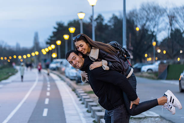 istock Young man giving girlfriend a piggyback ride at sunset 2225964855