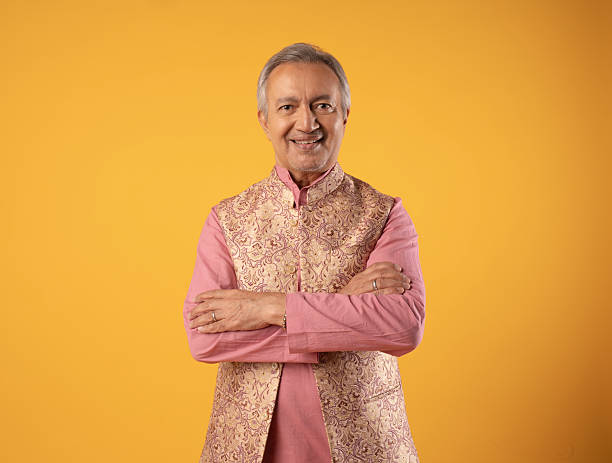 istock Cheerful senior man in kurta standing on yellow background 2225965483