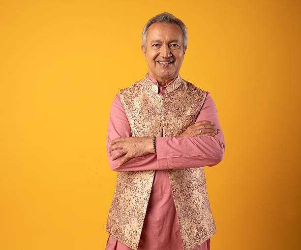 istock Cheerful senior man in kurta standing on yellow background 2225967421