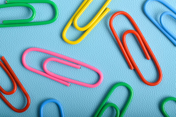 istock Colorful paper clips on light blue background 2225972499