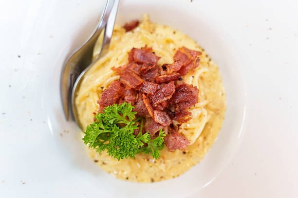 Carbonara pasta with egg yolk and bacon closeup background. Fast food delivery concept