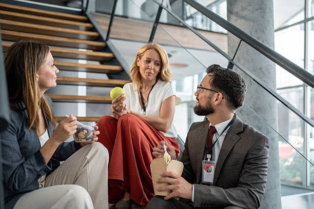 istock Businesspeople having lunch break together on office stairs 2225975069