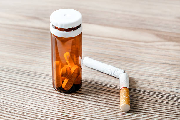 istock Pills and Cigarette on the Table 2225975216