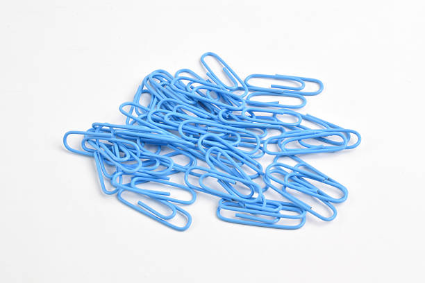istock Many blue paper clips on white background 2225975579