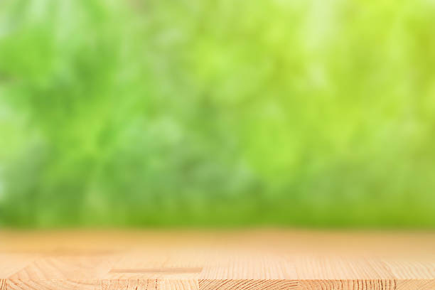 istock Wood table with natural green background 2225976006