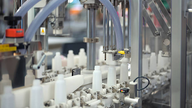 istock Automation drinking and packaging technology high-speed filling and capping line with clear plastic bottles in beverage or chemical production | automated liquid packaging line in industrial factory 2225980404
