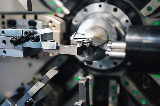 istock Automated multi-axis machine processing metal  shaping springs for manufacturing applications industrial robotic system rotating tools in high-efficiency smart production line 2225980614