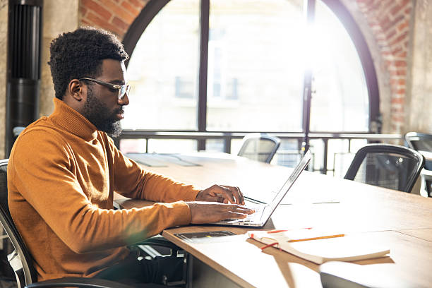 istock African american young man working at the laptop and looking focused 2225990806