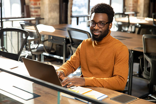 istock African american young man with laptop working in the office 2225990809