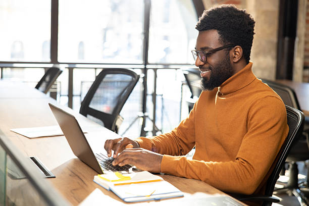 istock African american young man with laptop working in the office 2225990812