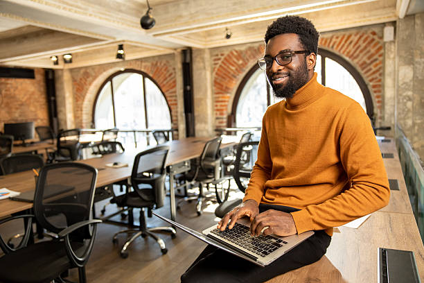 istock African american young man with laptop working in the office 2225990826