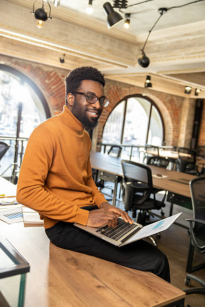 istock African american young man with laptop working in the office 2225990836