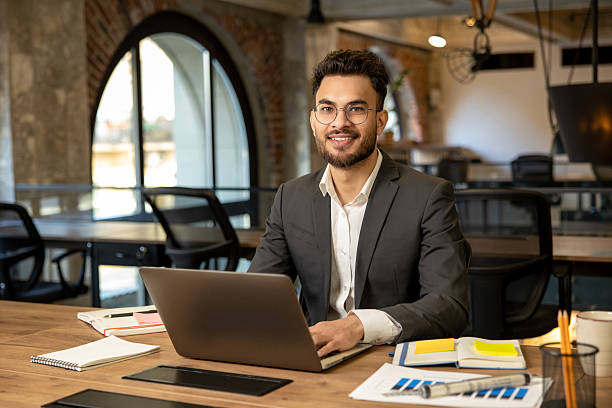istock Young caucasian man sitting in the office and having coffee 2225991079