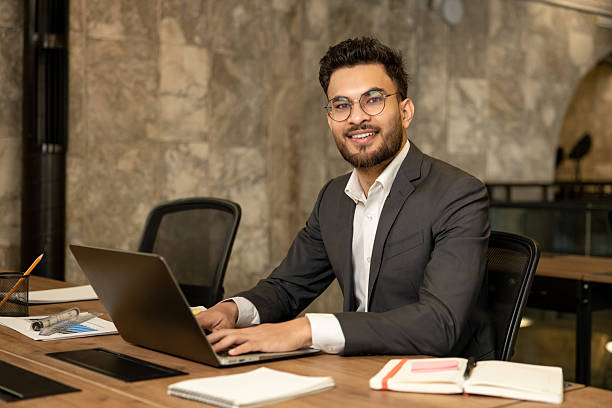istock Dark-haired young manager working in the office and looking confident 2225991113