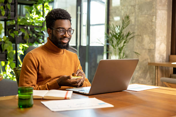 istock Man in glasses working on laptop reviewing digital reports 2225991267