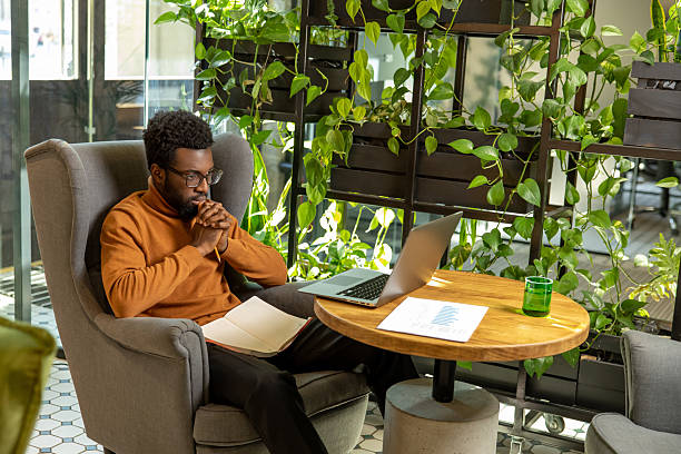 istock Male business owner seated at table managing workflow 2225991280