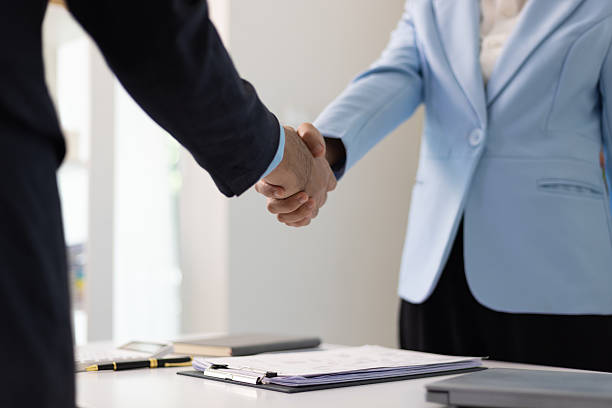 istock Job applicant submits resume documents, manager is interviewing new employee in office. Handshake during a job interview. 2225991689